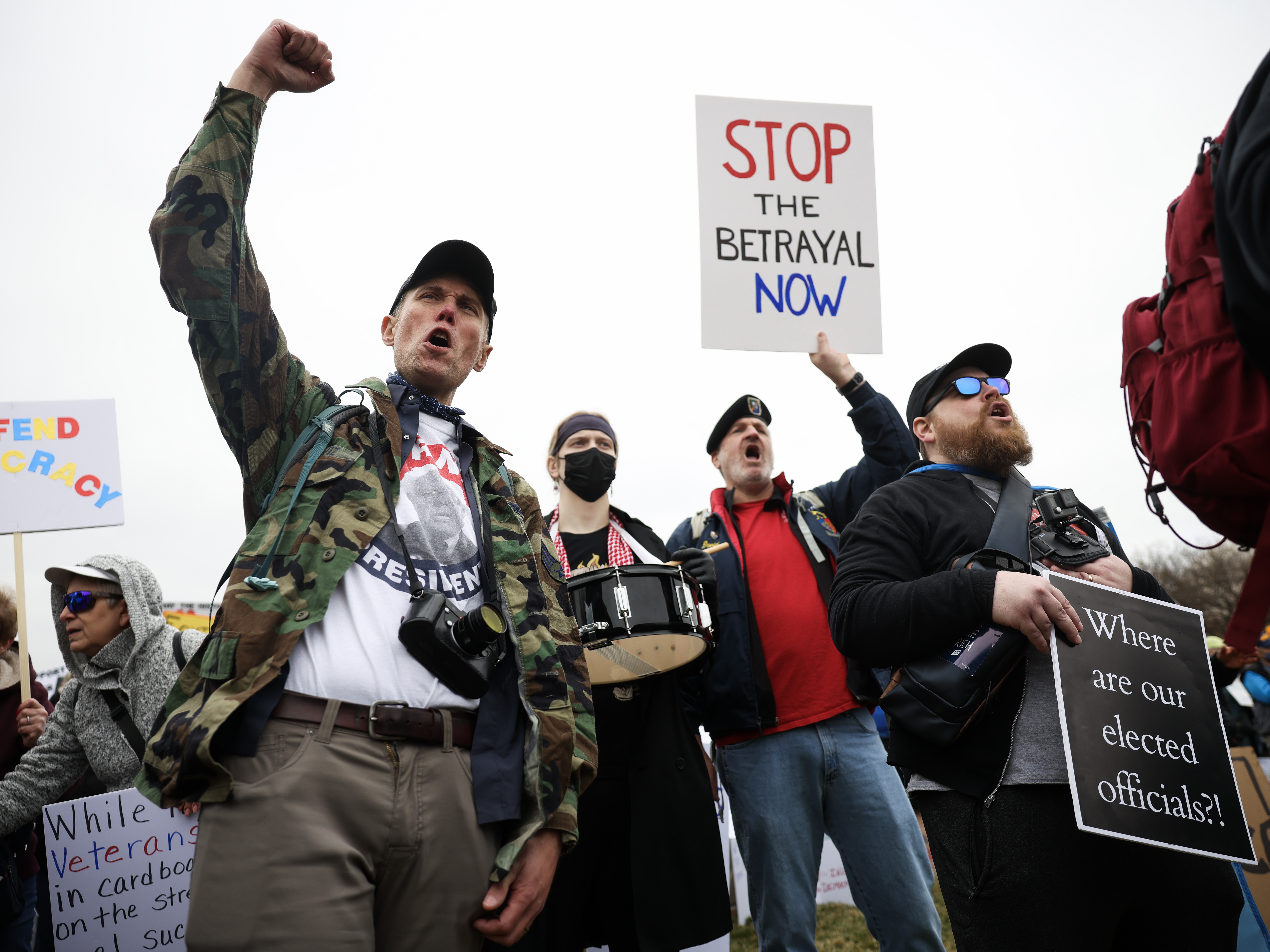 caption: Veterans marched in on the National Mall in D.C. on March 14 to protest President Trump and Elon Musk's plans to cut more than 70,000 workers from the Department of Veterans Affairs.