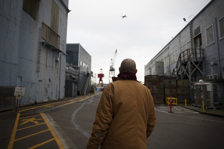 caption: Kevin Boggs walks into Vigor's Seattle ship yard to start his shift on Friday, December 14, 2018, in Seattle.