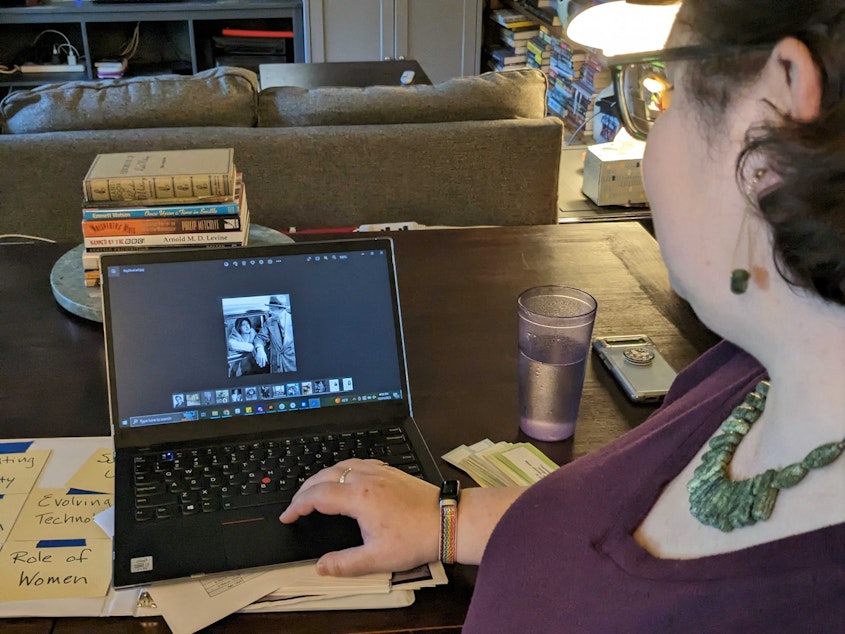 caption: Rebecca Demarest looks at a photo of Elise and Roy Olmstead. She's done extensive research on Elise's life.