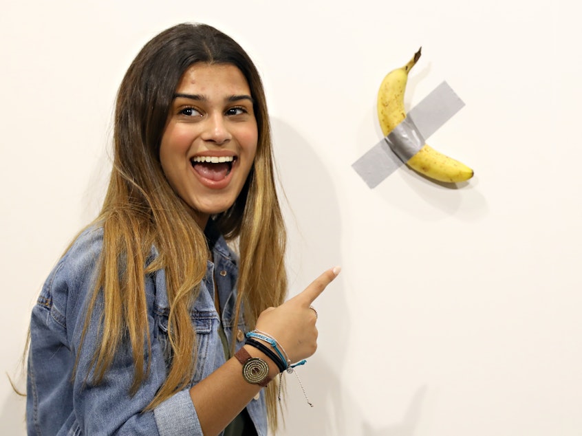 caption: An iteration of Maurizio Cattelan's "Comedian" has previously sold for $120,000, most famously at Art Basel Miami in 2019. A college student who recently viewed the art in a Seoul museum said he ate the banana after skipping breakfast.