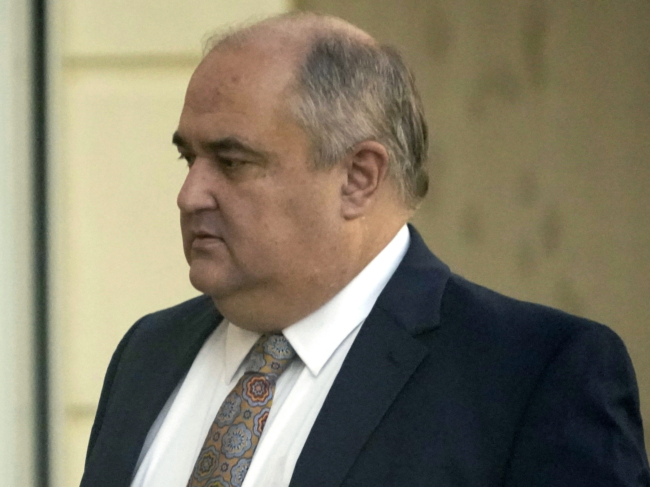 caption: John Davis, former director of the Mississippi Department of Human Services, enters the Thad Cochran United States Courthouse in Jackson, Miss., on Thursday, where he is pleaded guilty to new federal charges in a conspiracy to misspend tens of millions of dollars that were intended to help needy families.