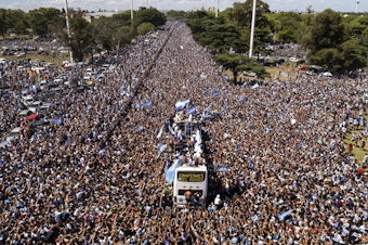 caption: The Argentine soccer team that won the World Cup title ride on an open bus during their homecoming parade in Buenos Aires, Argentina, Tuesday, Dec. 20, 2022.