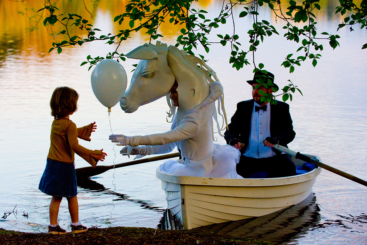 caption: In Lucia Neare's world, a horse can deliver balloons by row boat.