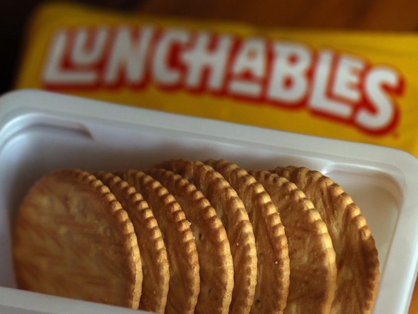 caption: In this photo illustration, a pack of Lunchables is displayed on Wednesday in San Anselmo, Calif. Consumer Reports is asking for the Department of Agriculture to eliminate Lunchables food kits from the National School Lunch Program after finding high levels of lead, sodium and cadmium in tested kits.