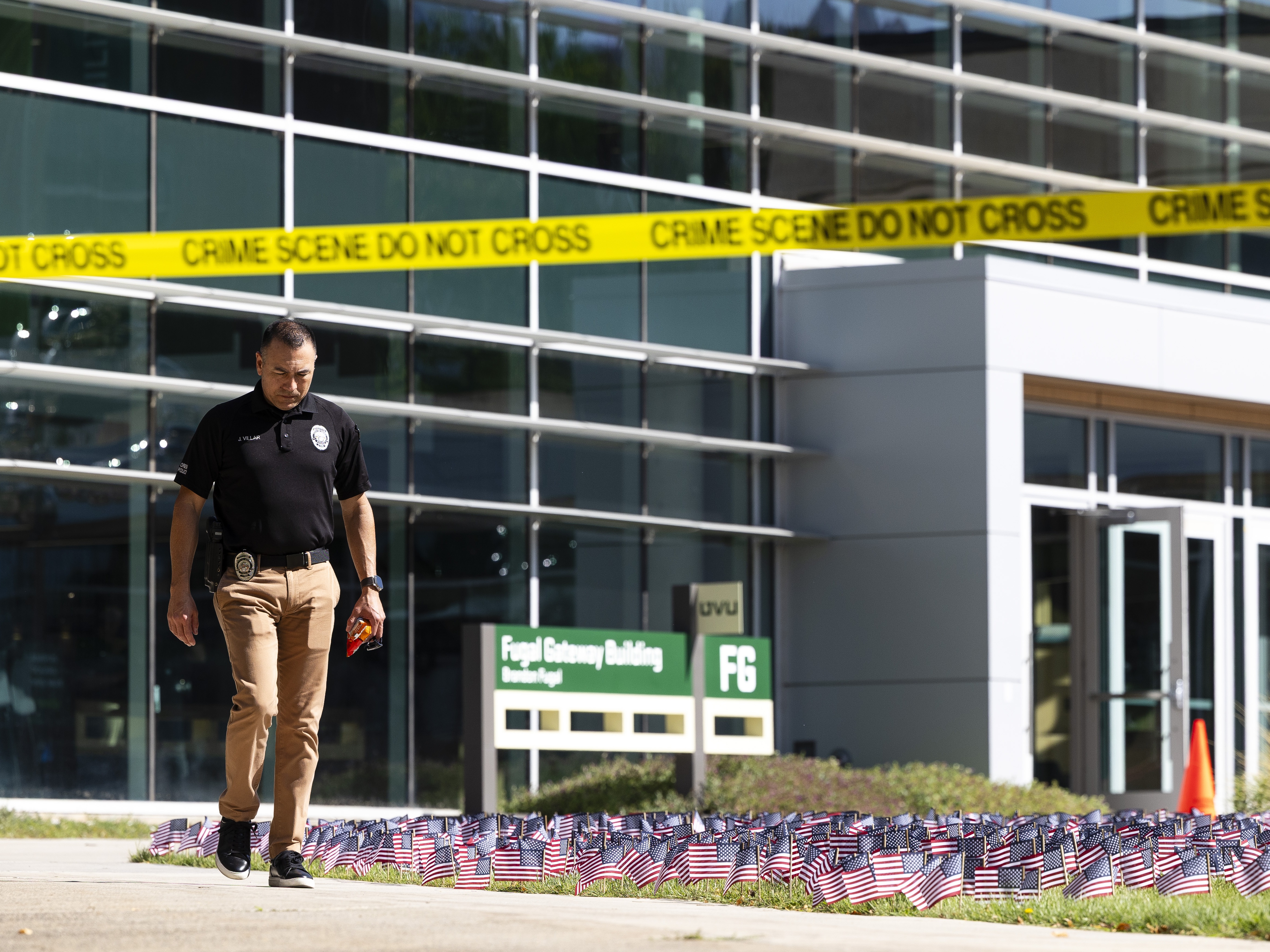 caption: A police officer walks out of a building at Utah Valley University as authorities investigate the fatal shooting of political activist Charlie Kirk. Conservative influencers have reacted with grief and anger to Kirk's killing.
