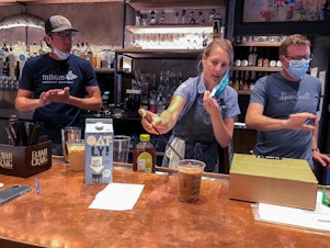 caption: Lauren Moran, a pastry chef who owns a bakery and café, taste-tests Cornwall's new coffee drinks with her husband, Cornwall's general manager Billy Moran (L), and Speedwell Coffee Company owner Derek Anderson.
