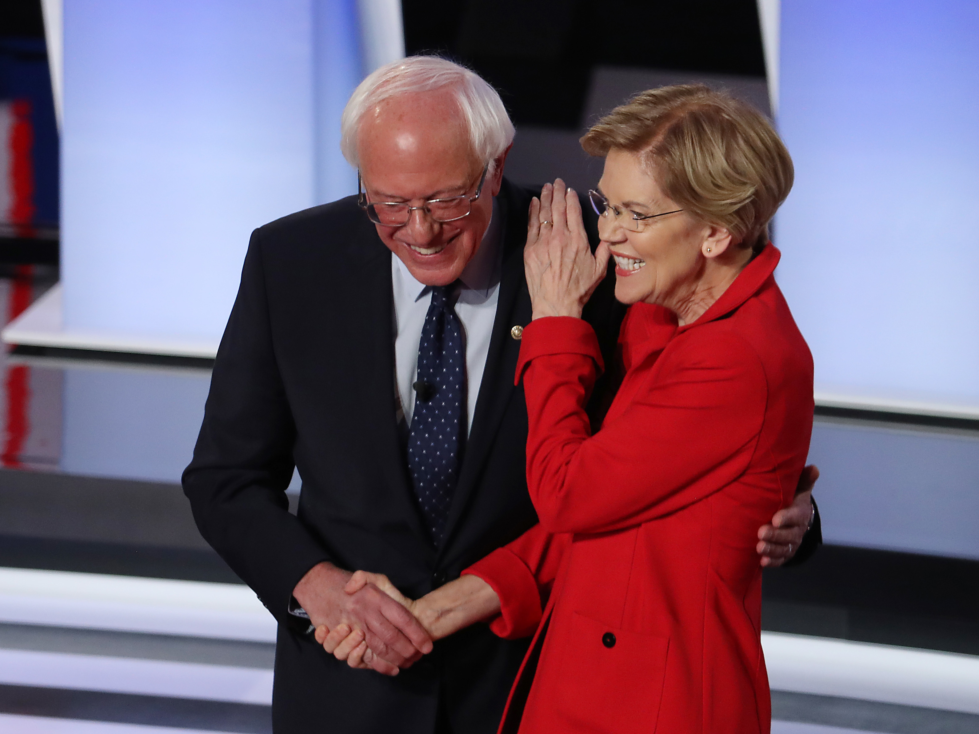 caption: Sanders and Warren greet each other at the start of Tuesday night's debate.