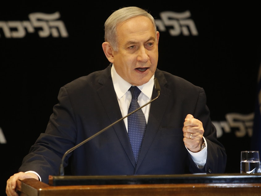 caption: Israeli Prime Minister Benjamin Netanyahu speaks at a press conference Wednesday in Jerusalem regarding his intention to file a request to the Knesset for immunity from prosecution.