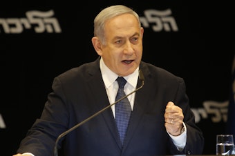 caption: Israeli Prime Minister Benjamin Netanyahu speaks at a press conference Wednesday in Jerusalem regarding his intention to file a request to the Knesset for immunity from prosecution.