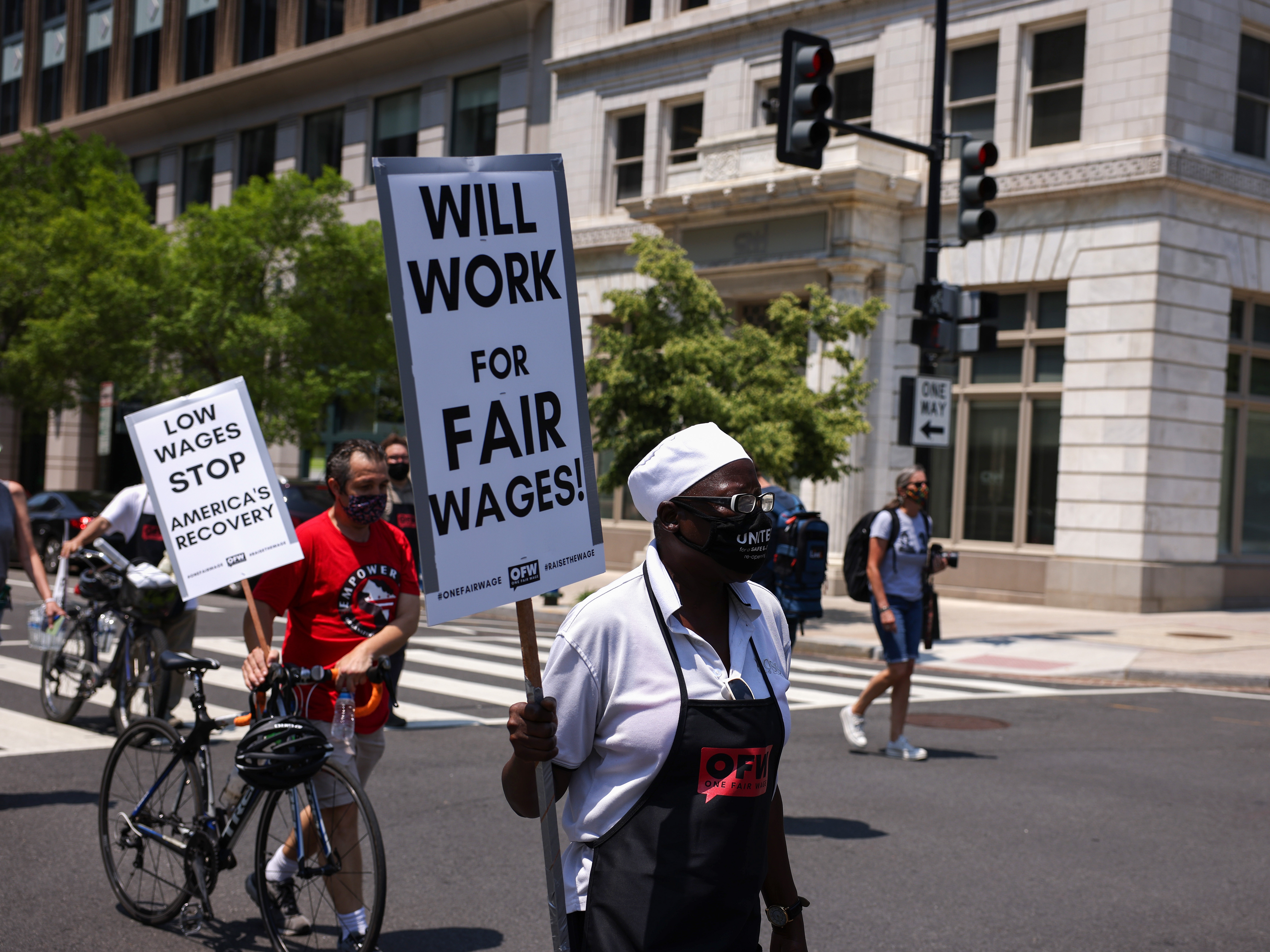 caption: A protester participates in a “wage strike" demonstration on May 26th, 2021 in Washington, DC.