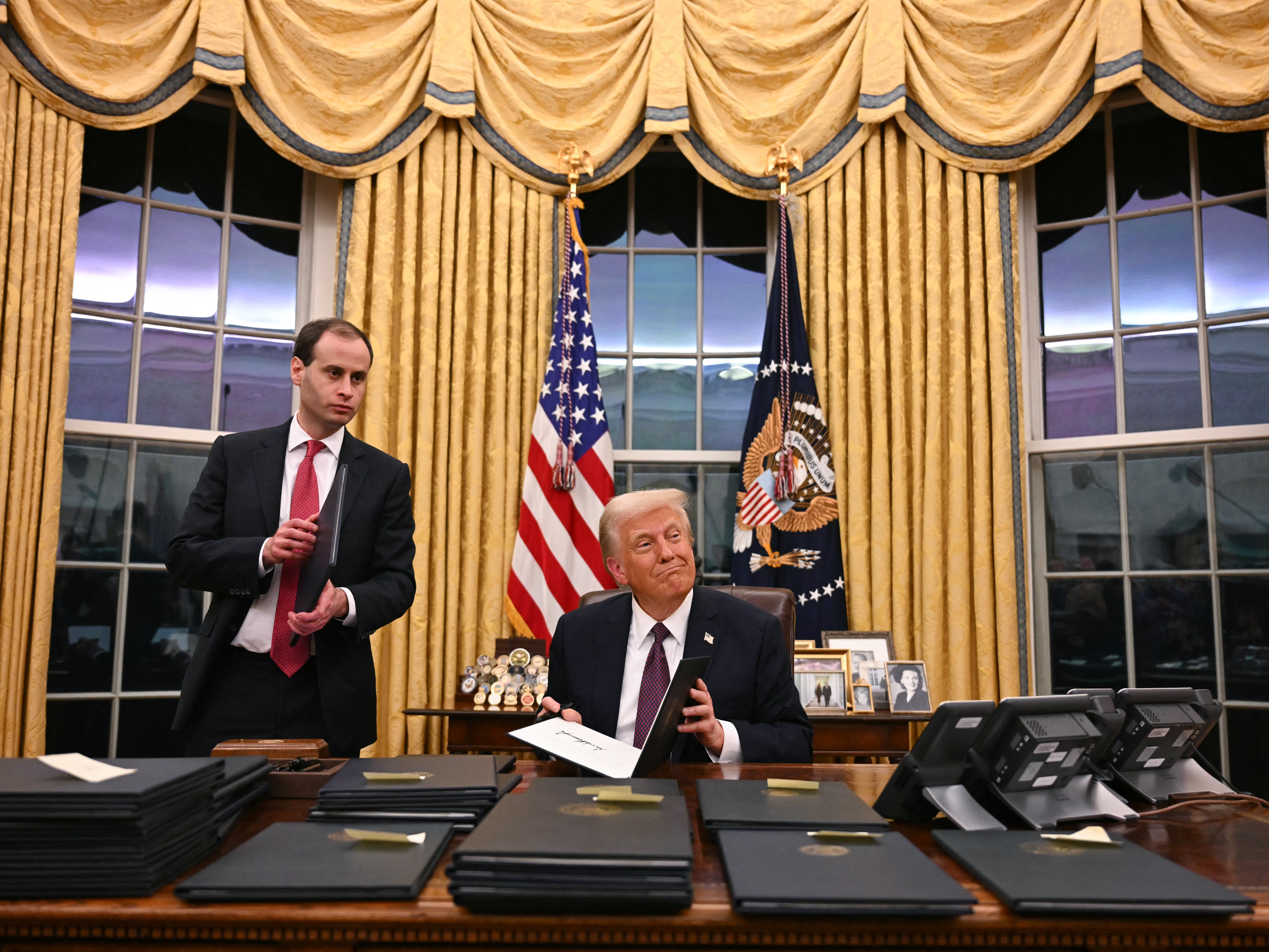 caption: President Trump signs executive actions  at the White House after his inauguration Monday. Among those orders is one labeling Mexican drug cartels terrorist organizations.