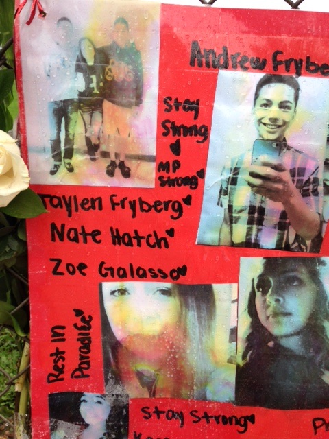 caption: Photos of the students shot at Marysville-Pilchuck High School are seen in a memorial last year.