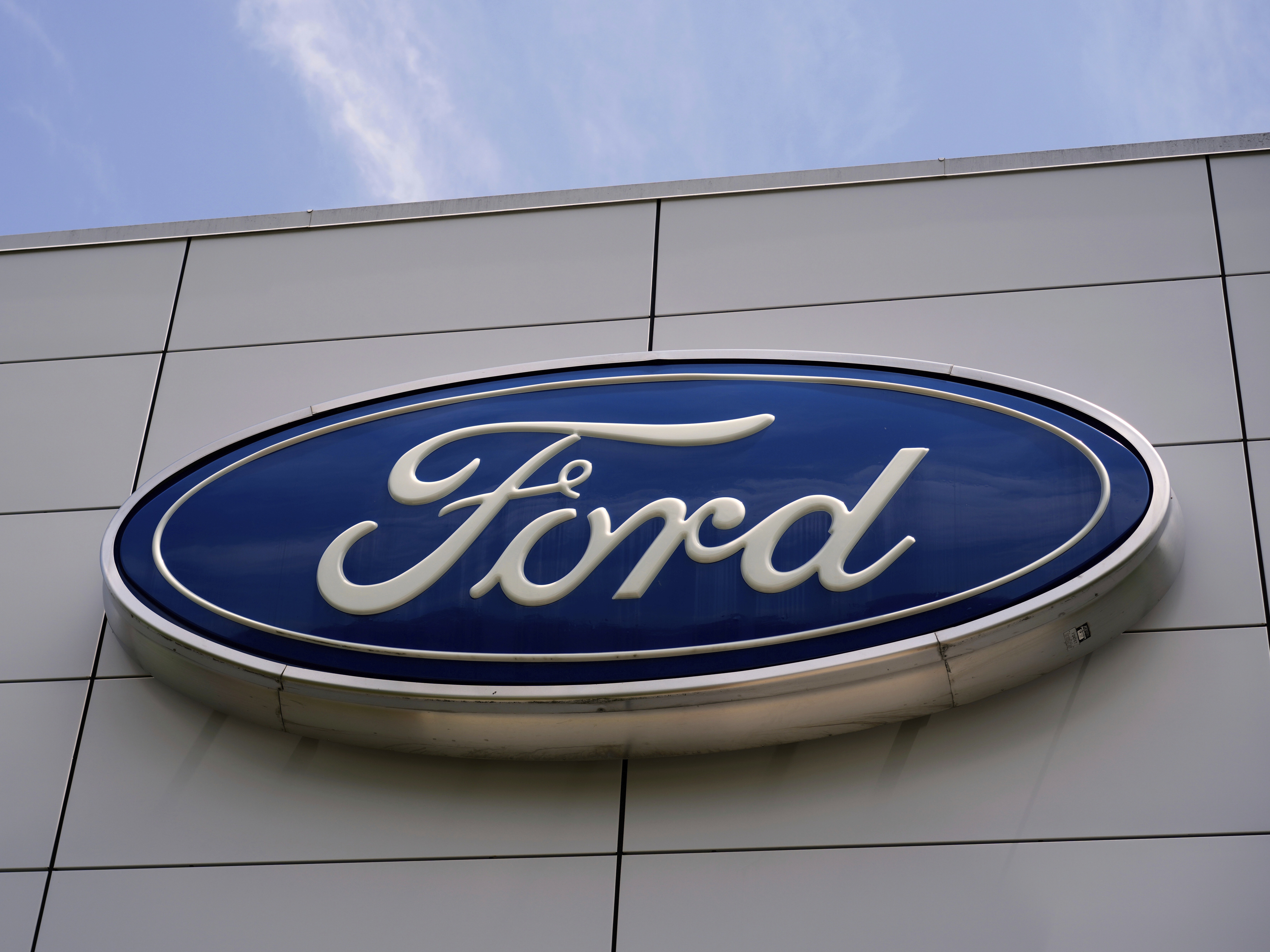 caption: The Ford logo is seen above the entrance to the Ford Motor Company Kentucky Truck Plant in Louisville, Ky.