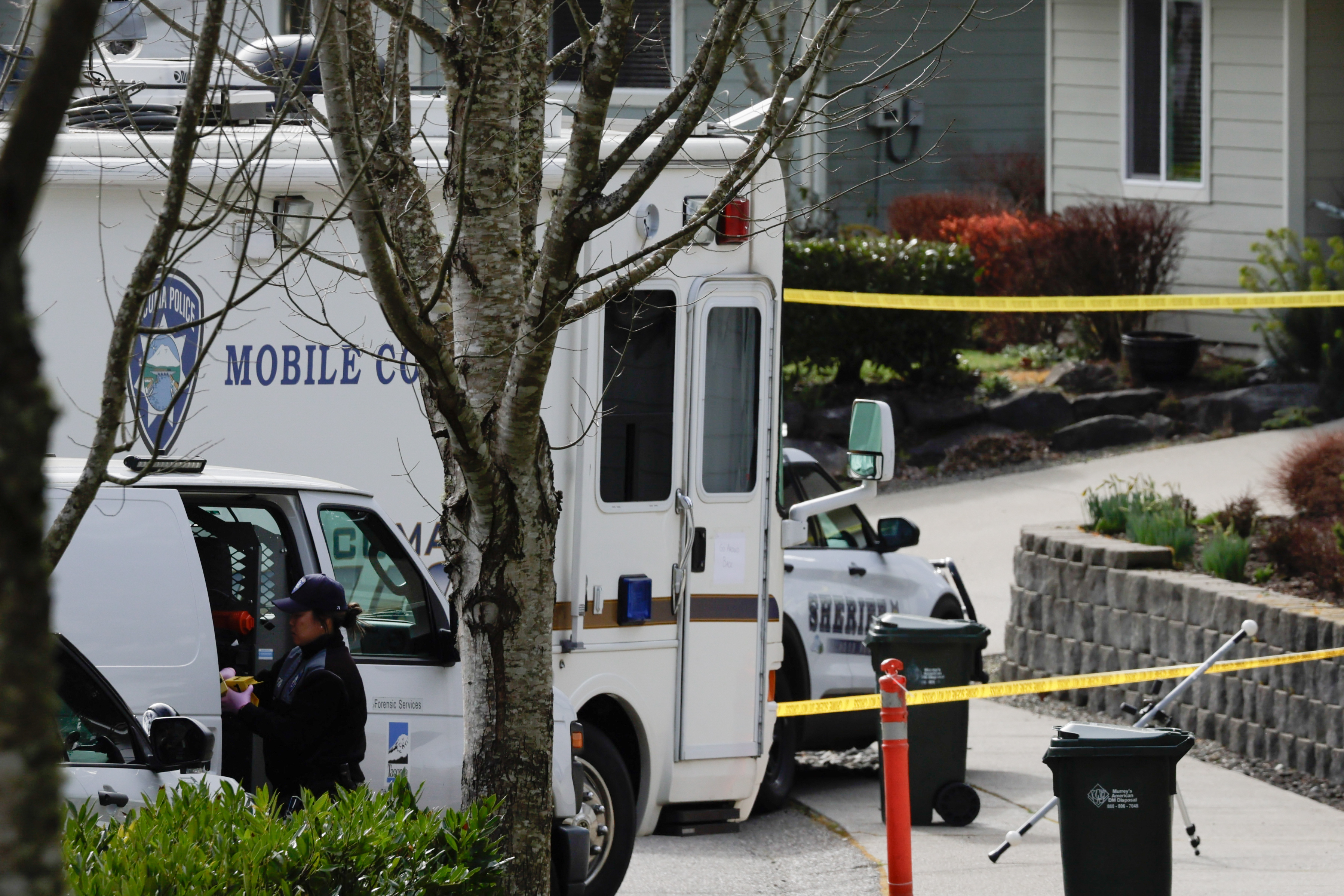 caption: Authorities investigate the scene after reports that a man fatally stabbed multiple people Tuesday, Feb. 24, 2026, in Gig Harbor, Wash. 