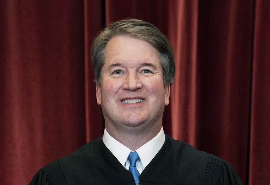 caption: Associate Justice Brett Kavanaugh stands during a group photo at the Supreme Court in Washington last year.