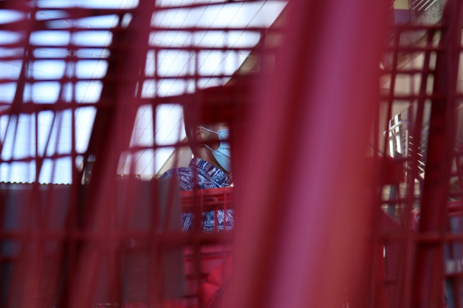 caption: A glimpse of one of my managers cleaning carts. Cleaning the carts has taken on new importance during the coronavirus pandemic. We are considered essential workers, because grocery stores are necessary.