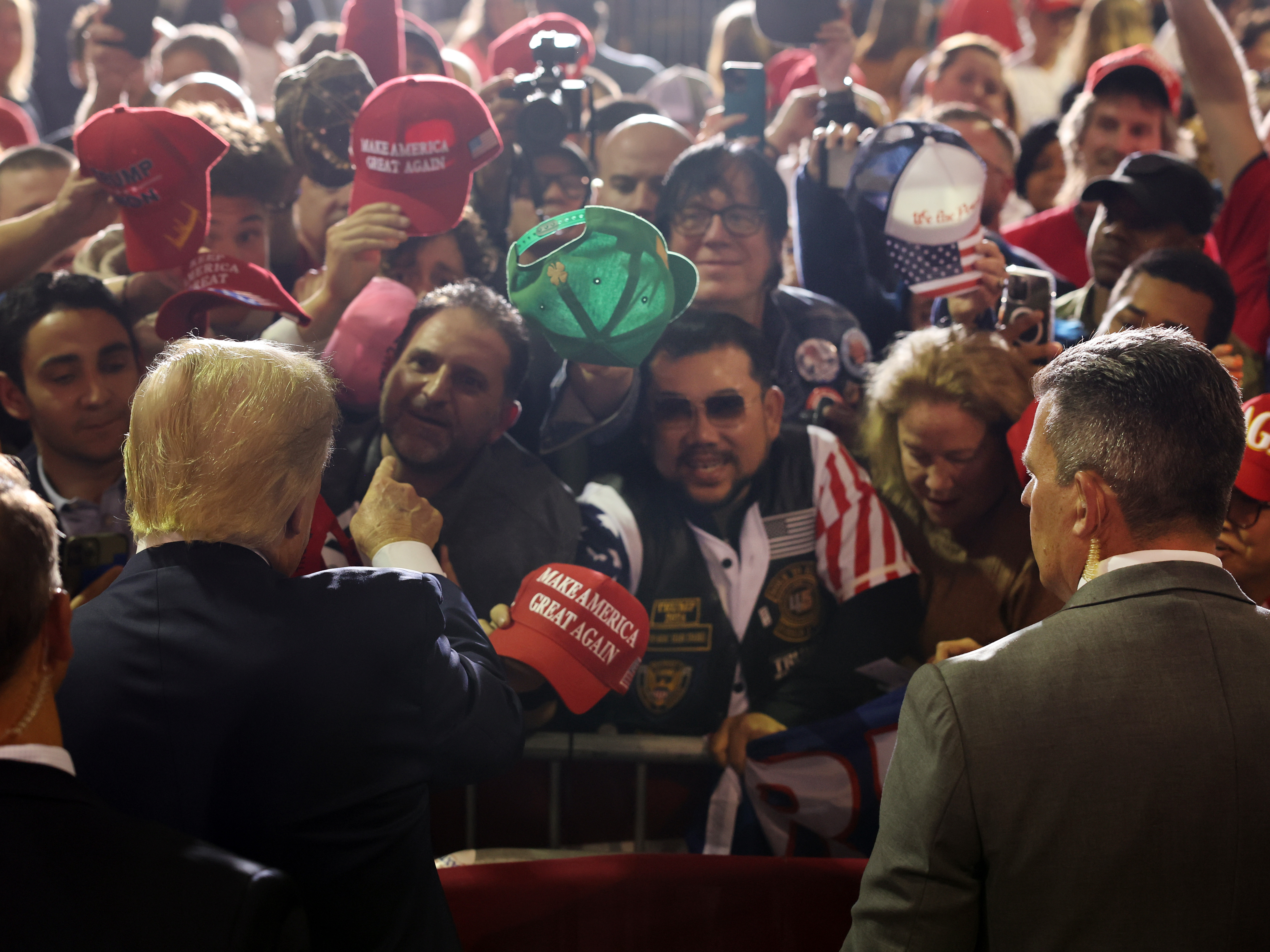 caption: Former President Donald Trump greets supporters at a campaign rally on April 27, 2023 in Manchester, N.H.