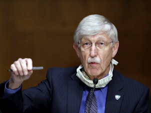 caption: National Institutes of Health Director Dr. Francis Collins speaks during a Senate hearing earlier this year. On Thursday, Collins called on religious leaders to keep their worship spaces closed, despite rising protests from some church leaders.