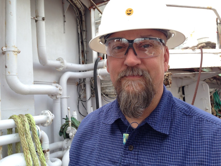 caption: Alan Davis, Safety and Compliance Director for American Seafoods of Seattle, on the deck of the Nothern Eagle
