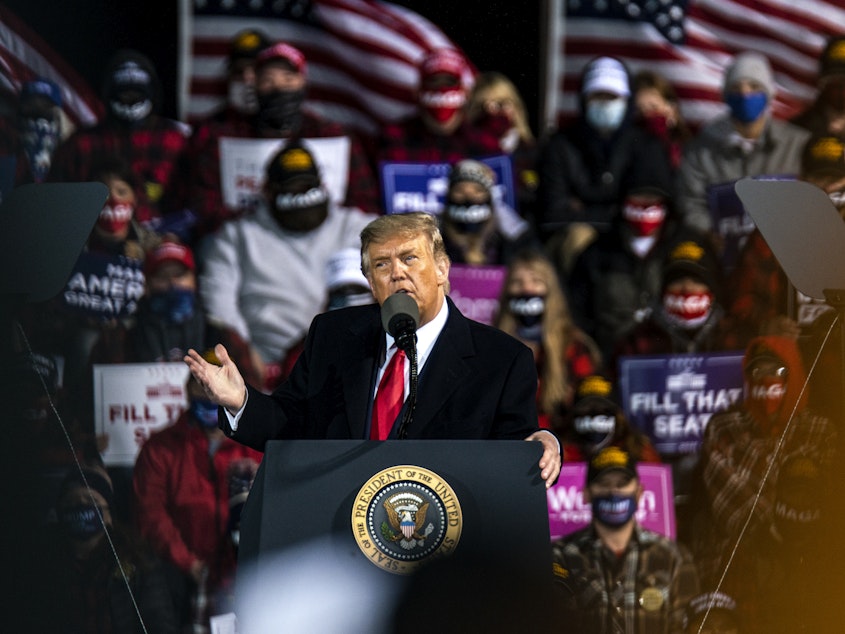 caption: Trump speaks during a campaign rally at the Duluth International Airport on Sept. 30, 2020 in Duluth, Minn.