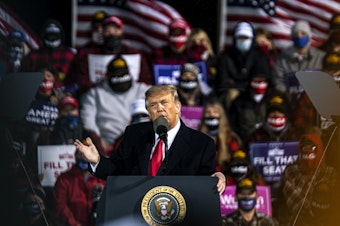 caption: Trump speaks during a campaign rally at the Duluth International Airport on Sept. 30, 2020 in Duluth, Minn.