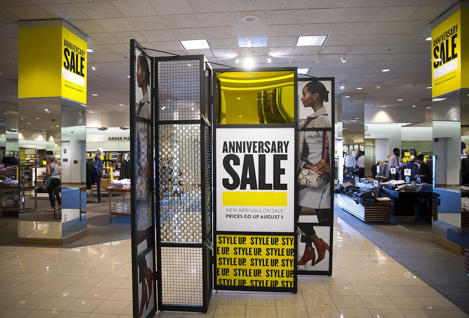 caption: Yellow sale signs are shown inside Nordstrom on Monday, July 22, 2019, at Northgate Mall in Seattle.