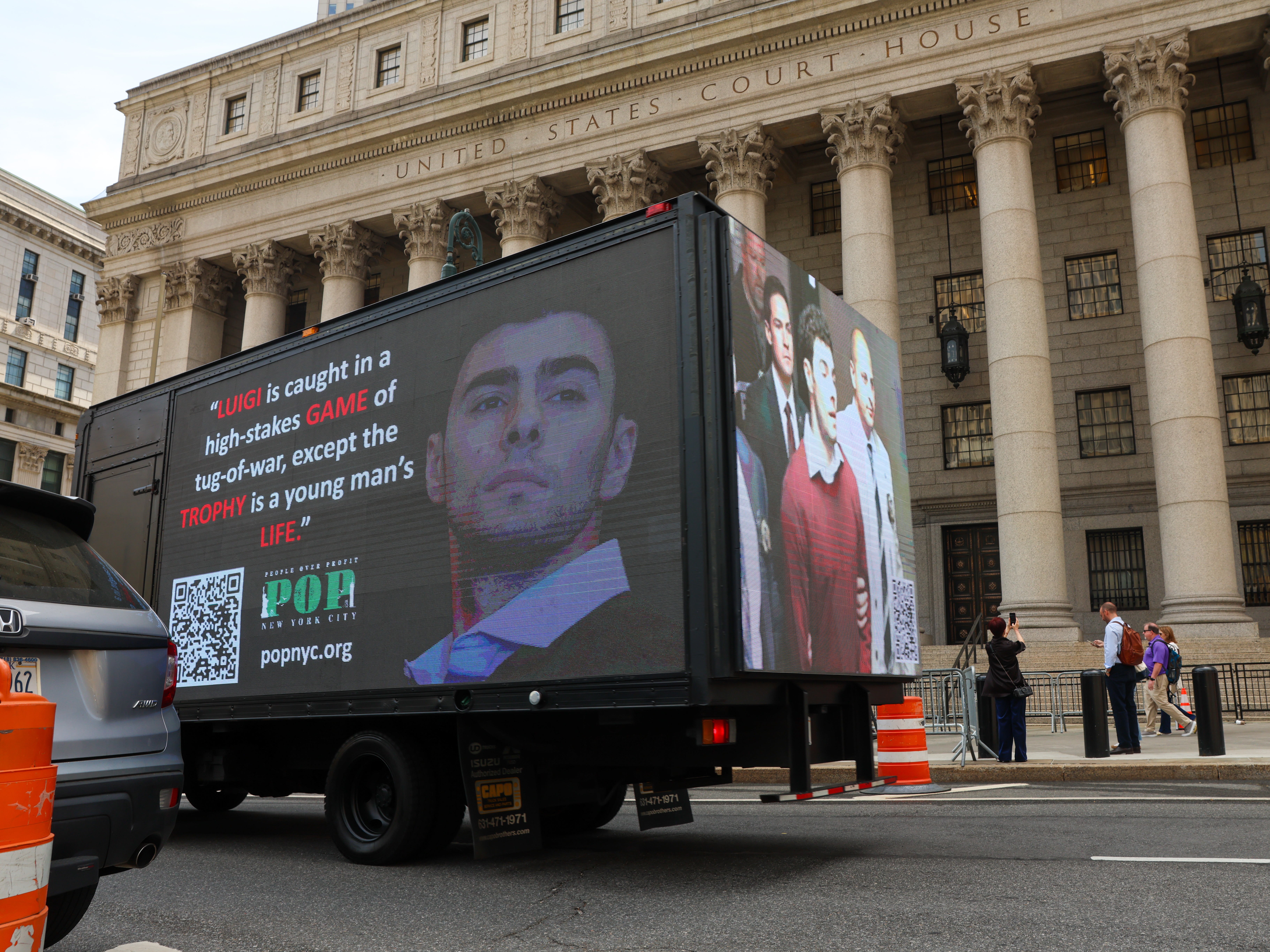 caption: A truck displays pictures of Luigi Mangione on April 25, 2025 in New York City, as he was set to appear for the arraignment on charges that he murdered the CEO of UnitedHealthcare last year.
