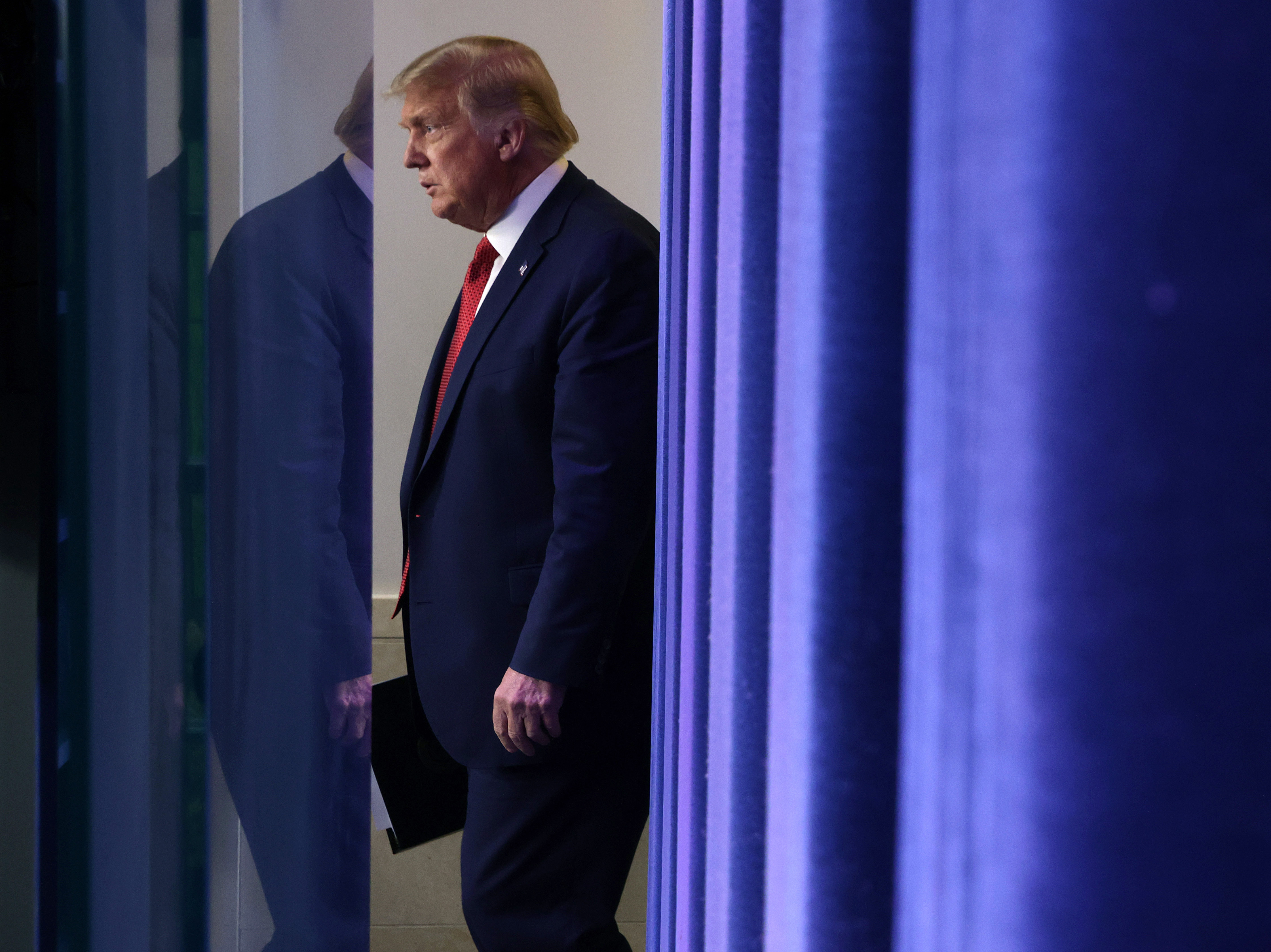 caption: President Trump walks up to speak during a news conference Monday, minutes before being interrupted by news of a shooting outside the White House.