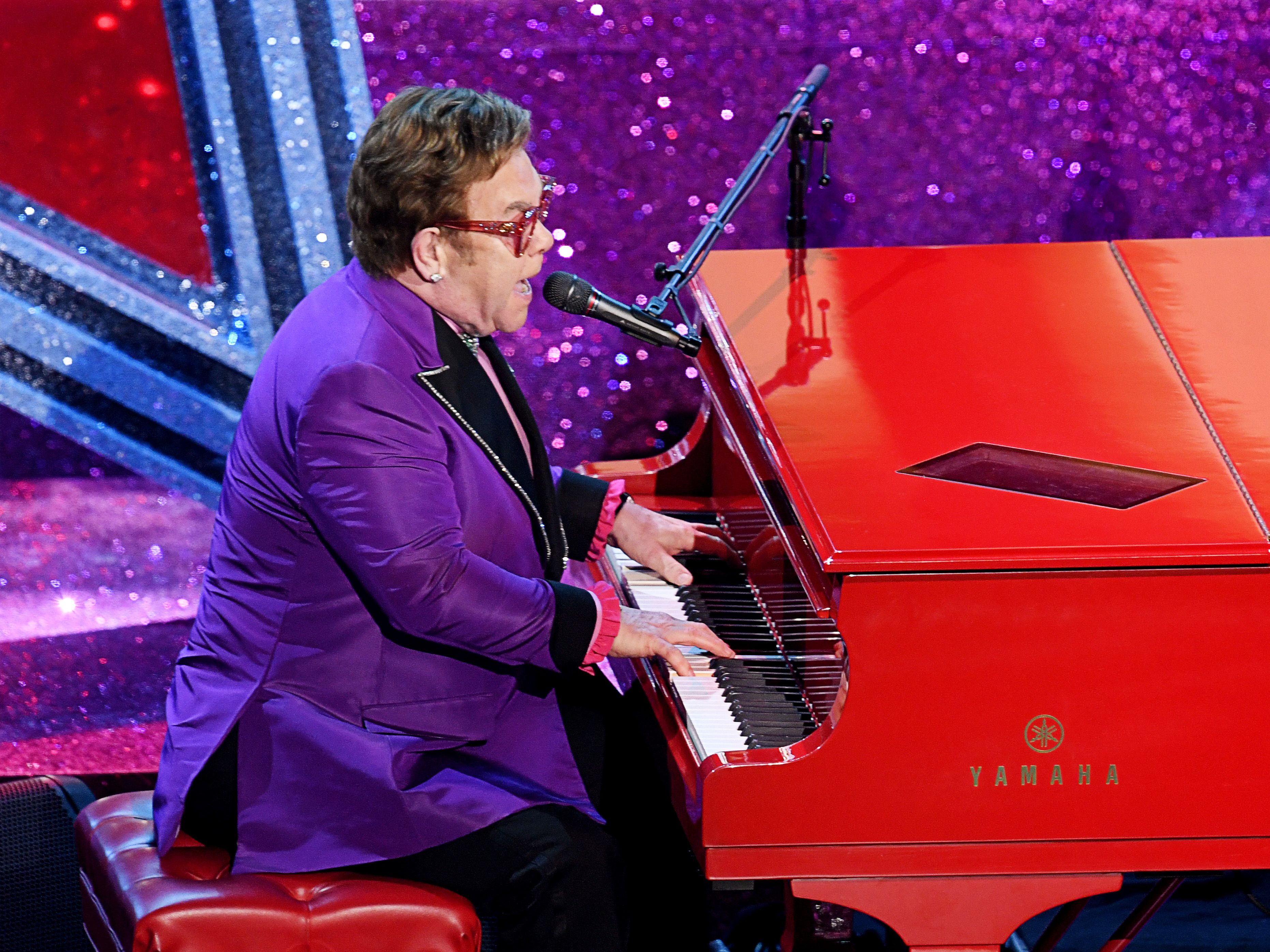 caption: Elton John performs at the Academy Awards on Feb. 9 in Los Angeles. He had to end a show in New Zealand early. He told his fans: "I gave it all I had."