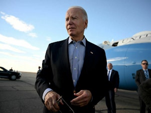 caption: President Biden speaks to reporters before boarding Air Force One at Pueblo Memorial Airport in Pueblo, Colo., on Nov. 29.