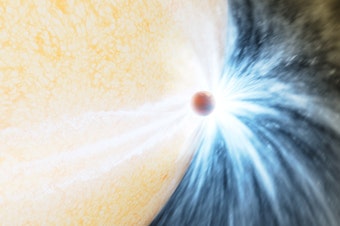 caption: An artist's impression of an aging star swelling up and beginning to engulf a planet, much like the Sun will do in about 5 billion years.