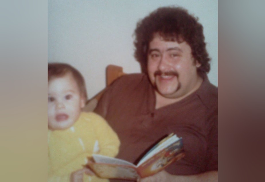 caption: The author as a baby with her father.