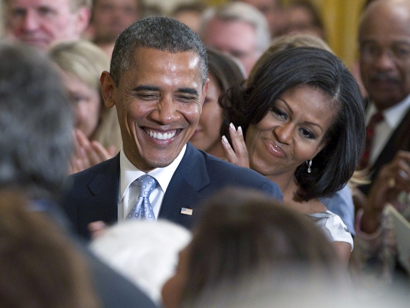 caption: President Barack Obama and first lady Michelle Obama applaud former President George H.W. Bush and former first lady Barbara Bush, not seen, during the portrait unveiling ceremony for former President George W. Bush and former first lady Laura Bush portraits, May 31, 2012, in the East Room of the White House. Obama's presidential portrait will be unveiled on Wednesday.