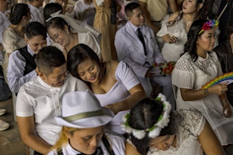 caption: Filipino same-sex couples tie the knot in a mass wedding ceremony on June 25, 2023, in Quezon City in metro Manila, Philippines. In a symbolic act against the lack of comprehensive legislation for gender minorities in the Philippines, 29 same-sex couples tied the knot in a mass wedding ceremony organized by the LGBTS (Let God Be Thy Savior) Christian Church Inc.