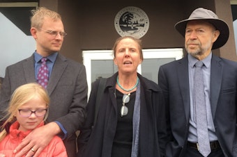 caption:  Defendant Emily Johnston (center) speaks outside Clearwater County courthouse, with co-defendant Ben Joldersma, left, and his daughter, and former NASA scientist James Hansen after she was acquitted along with two other defendants. Dan Kraker | MPR News 