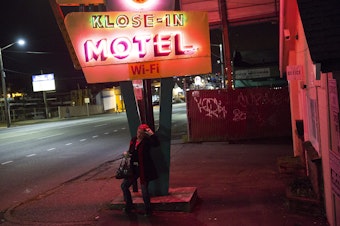 caption: Ericka Frodsham, 36, stands outside a motel on Aurora Avenue North in Seattle. She is homeless, living out of motel rooms. 