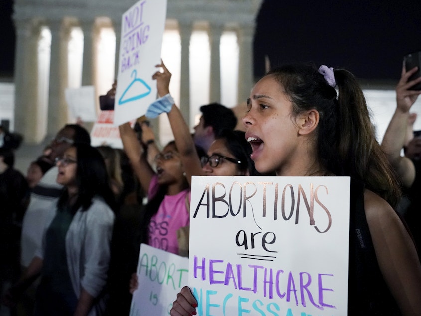 caption: A crowd of people gather outside the U.S. Supreme Court early on Tuesday after a draft opinion was leaked indicating the court could strike down Roe v. Wade.