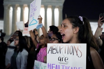 caption: A crowd of people gather outside the U.S. Supreme Court early on Tuesday after a draft opinion was leaked indicating the court could strike down Roe v. Wade.