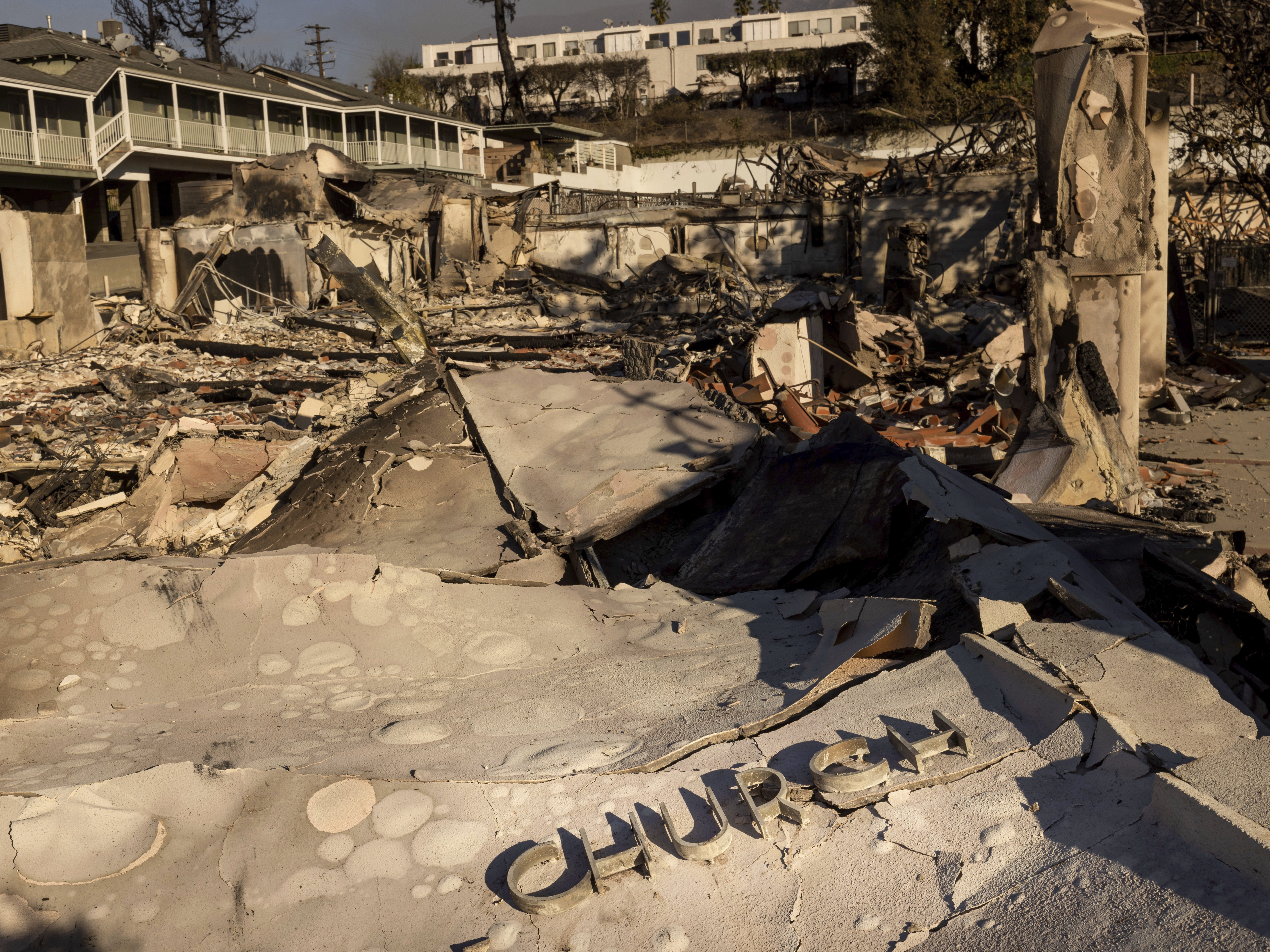 caption: The Altadena Community Church is left damaged by the Eaton Fire on Sunday in Altadena, Calif.