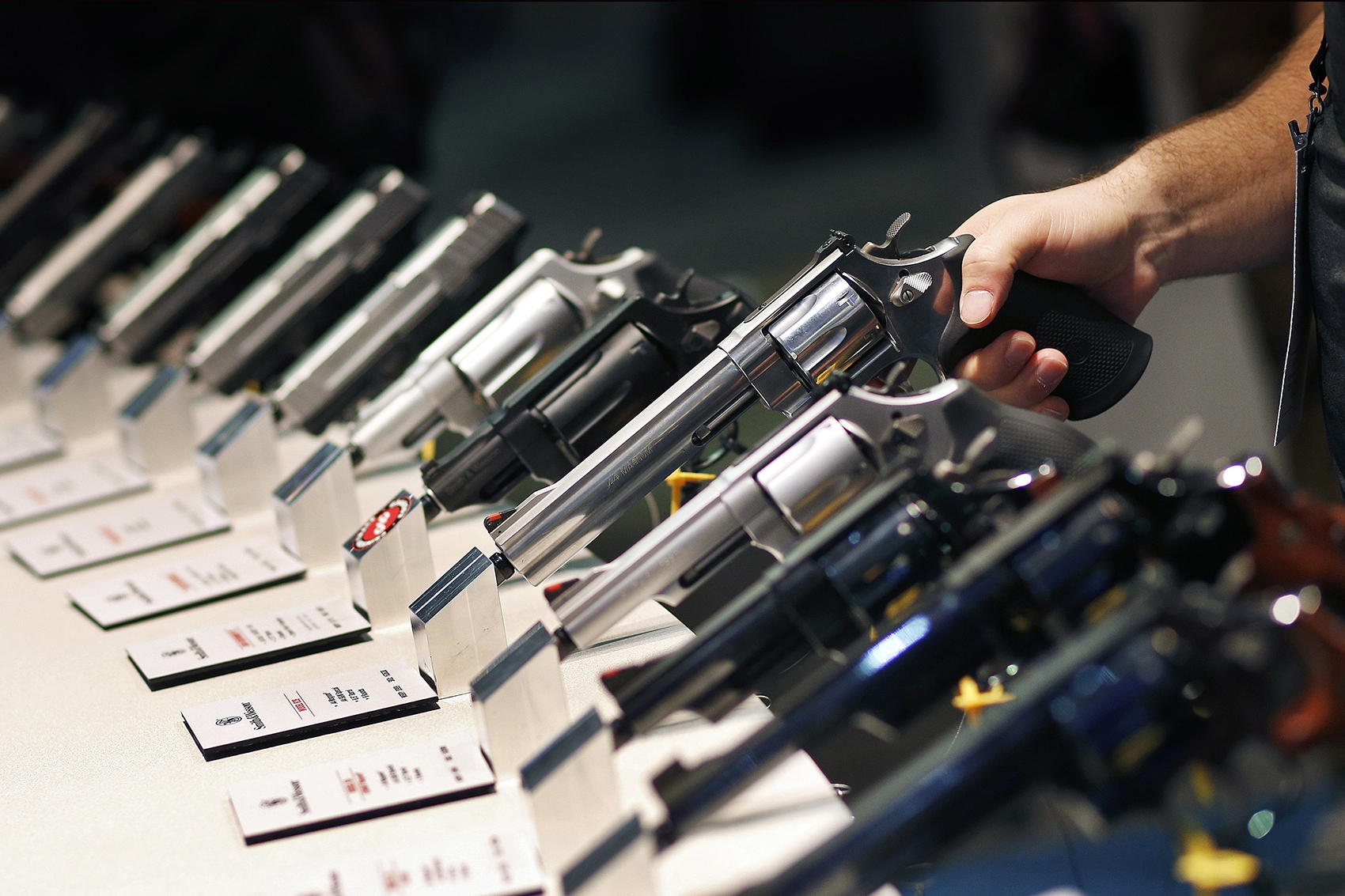 caption: In this Jan. 19, 2016 file photo, handguns are displayed at the Smith & Wesson booth at the Shooting, Hunting and Outdoor Trade Show in Las Vegas. (John Locher, File/AP)