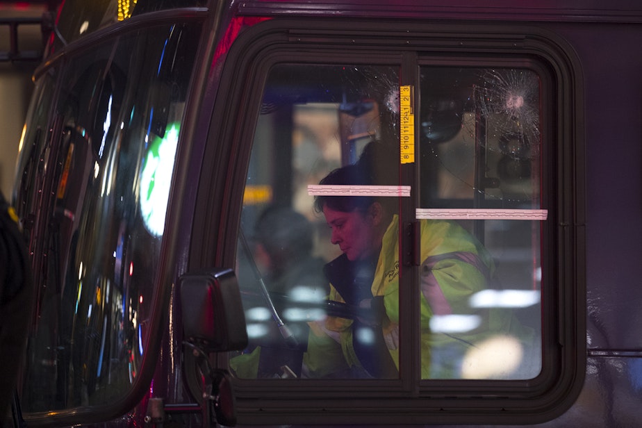 caption: Bullet holes are visible in a window of a metro bus following a shooting that left multiple victims injured and one dead on Wednesday, January 22, 2020, at the intersection of Third Avenue and Pike Street in Seattle.
