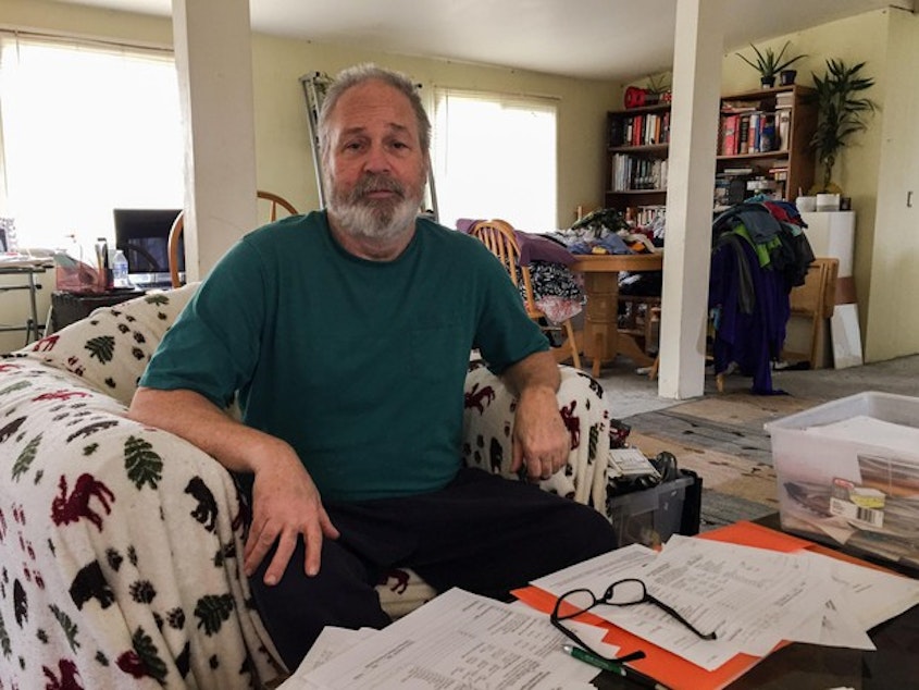 caption: <p>Nick Vervair sits on his couch looking over school records for his son. His boy was put in isolation at school on 17 different days in the 2014-15 school year, without the family knowing.&nbsp;</p>