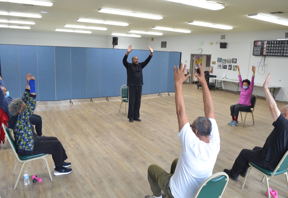 caption: Mark Bryant leads the Friday-morning Silver Sneakers class at the Southeast Seattle Senior Center in the Rainier Valley neighborhood.