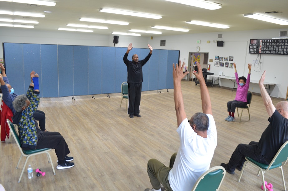 caption: Mark Bryant leads the Friday-morning Silver Sneakers class at the Southeast Seattle Senior Center in the Rainier Valley neighborhood.
