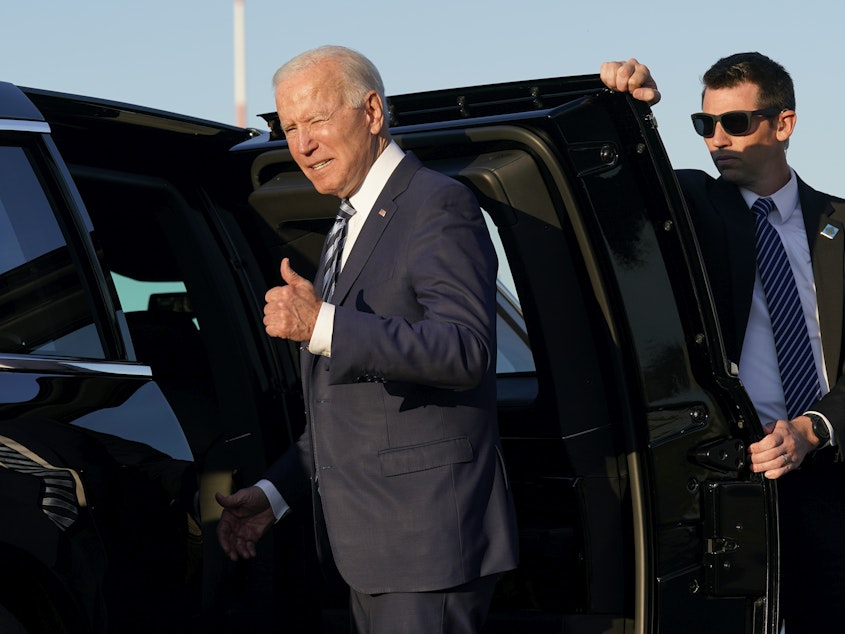 caption: "We have to end COVID-19 not just at home, which we're doing, but everywhere," President Joe Biden said on June 9 during his stop at Royal Air Force Mildenhall in Suffolk, England, on the first leg of his European trip. Above: Biden steps into a motorcade vehicle after arriving at RAF Mildenhall.