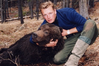 caption: Chris Morgan as a nervous 24-year-old with the first grizzly bear he ever captured while working on a research study in Canadian Rockies in 1994. Morgan named the bear Dawson. 