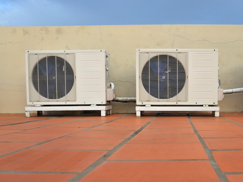 caption: Air conditioners on a building. HVAC installers report hundreds of calls in the wake of record high temperatures June 28 in the Pacific Northwest.