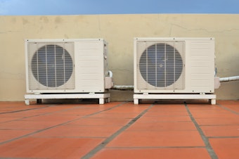 caption: Air conditioners on a building. HVAC installers report hundreds of calls in the wake of record high temperatures June 28 in the Pacific Northwest.