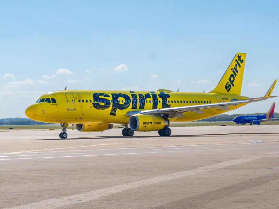 caption: A Spirit Airlines plane prepares to depart from the Austin-Bergstrom International Airport. The low-cost carrier plans to keep flying as it files for Chapter 11 bankruptcy protection.