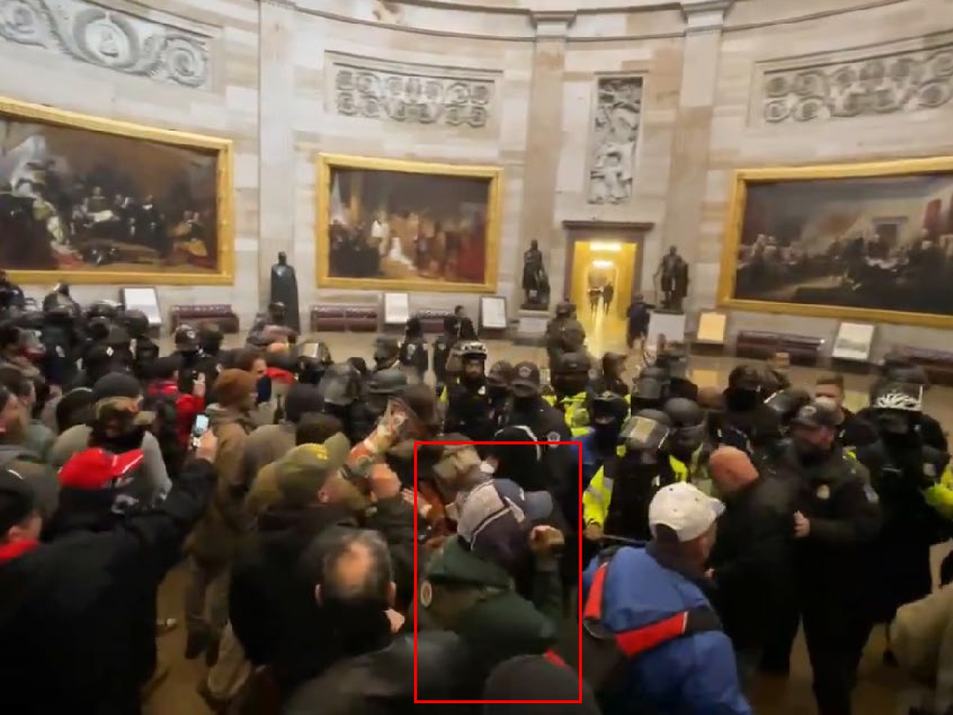 caption: A screenshot showing Glen Simon (highlighted in the red rectangle) entering the U.S. Capitol Rotunda on Jan. 6, 2021. Prosecutors cited this photo in the case against Glen Simon. A coalition of media organizations said Tuesday that video evidence from Simon's case had "disappeared" from a government platform.